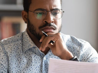 Man reviewing debt on his computer.