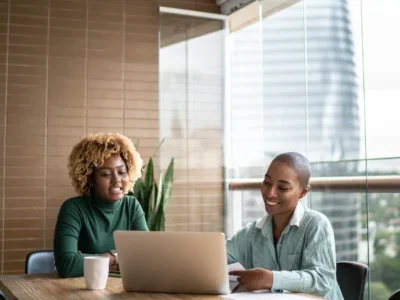 Two women discuss debt management and debt settlement