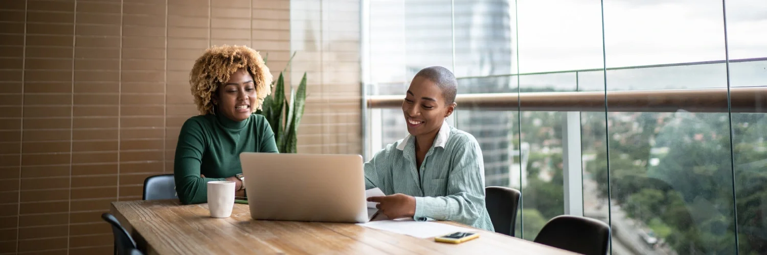 Two women discuss debt management and  debt settlement