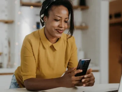 Female business owner making online purchases on her smartphone.