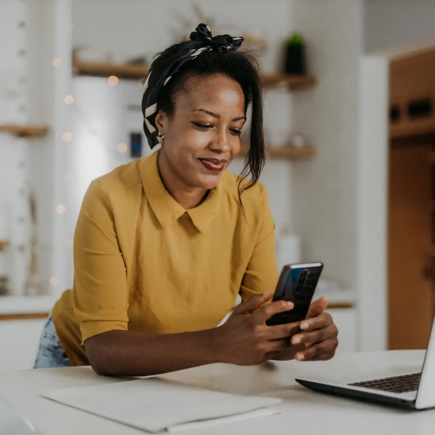 Female business owner making online purchases on her smartphone.