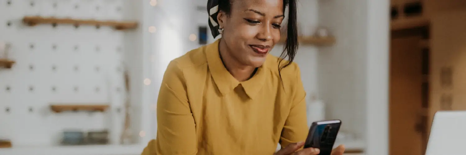 Female business owner making online purchases on her smartphone.